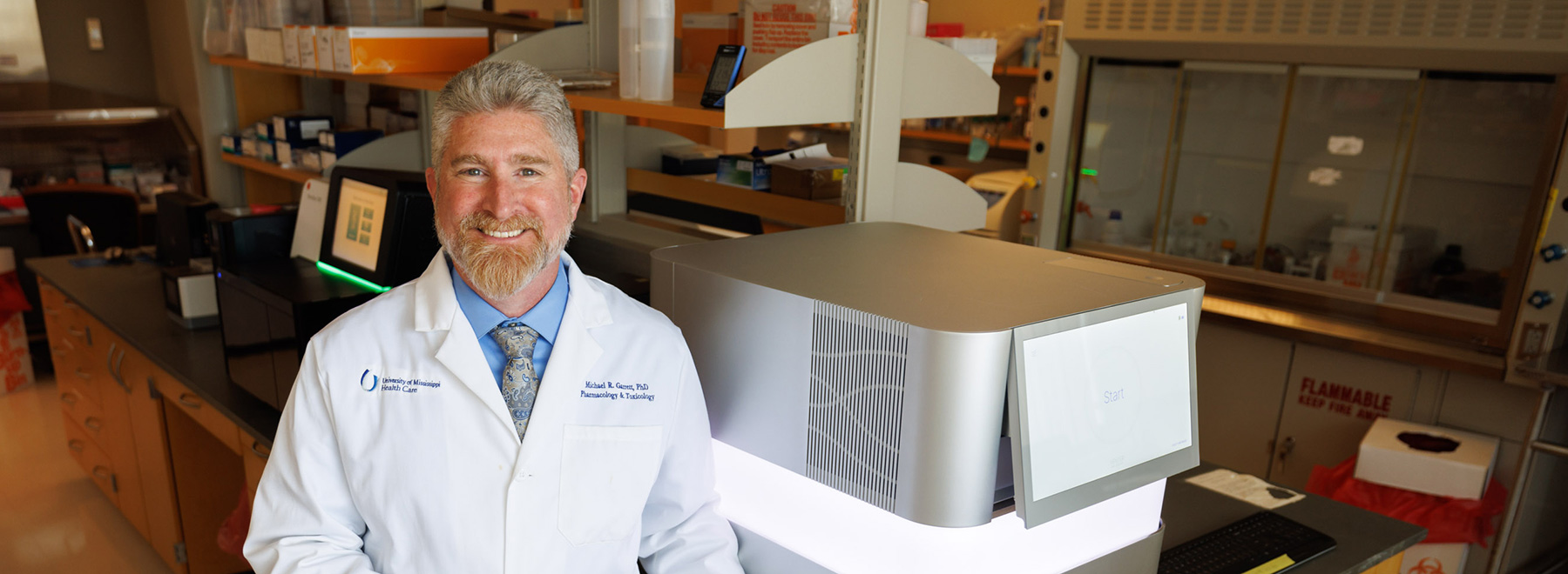 Dr. Michael Garrett Garrett stands in the Molecular and Genomics Core Facility that he established in 2010.